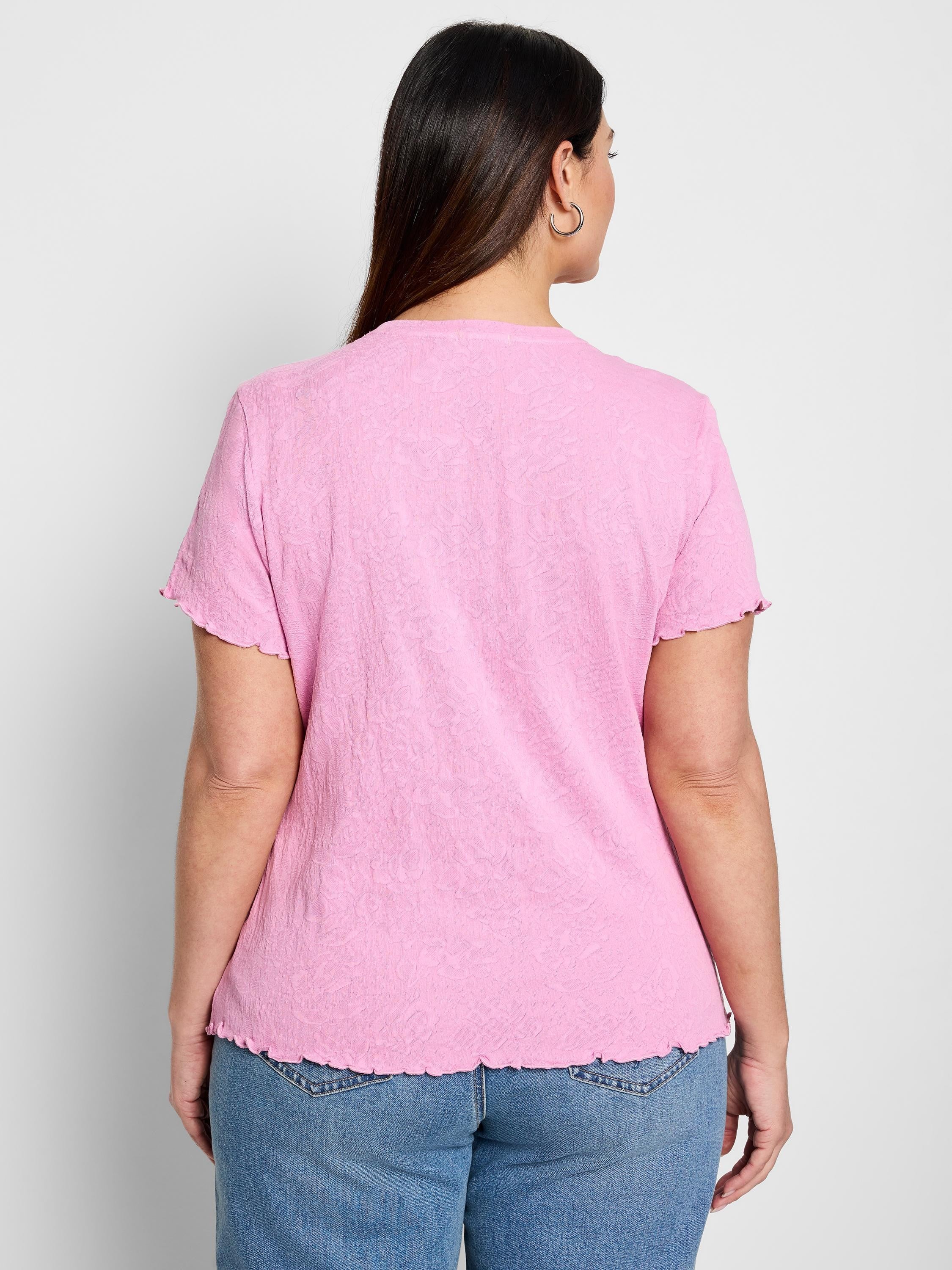Pink textured knit t-shirt with short, scalloped sleeves and hem.