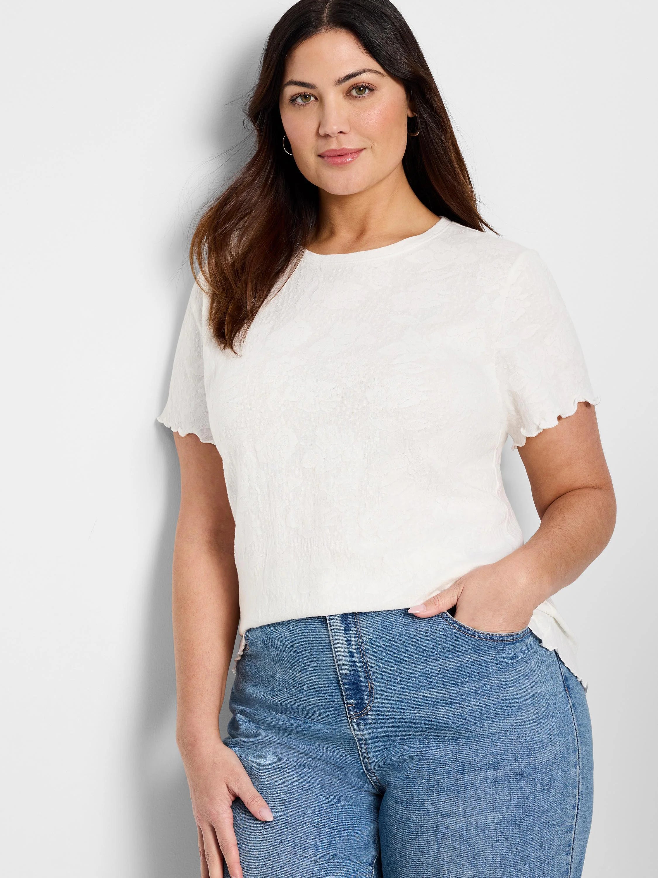 Off-white textured knit t-shirt with scalloped short sleeves.