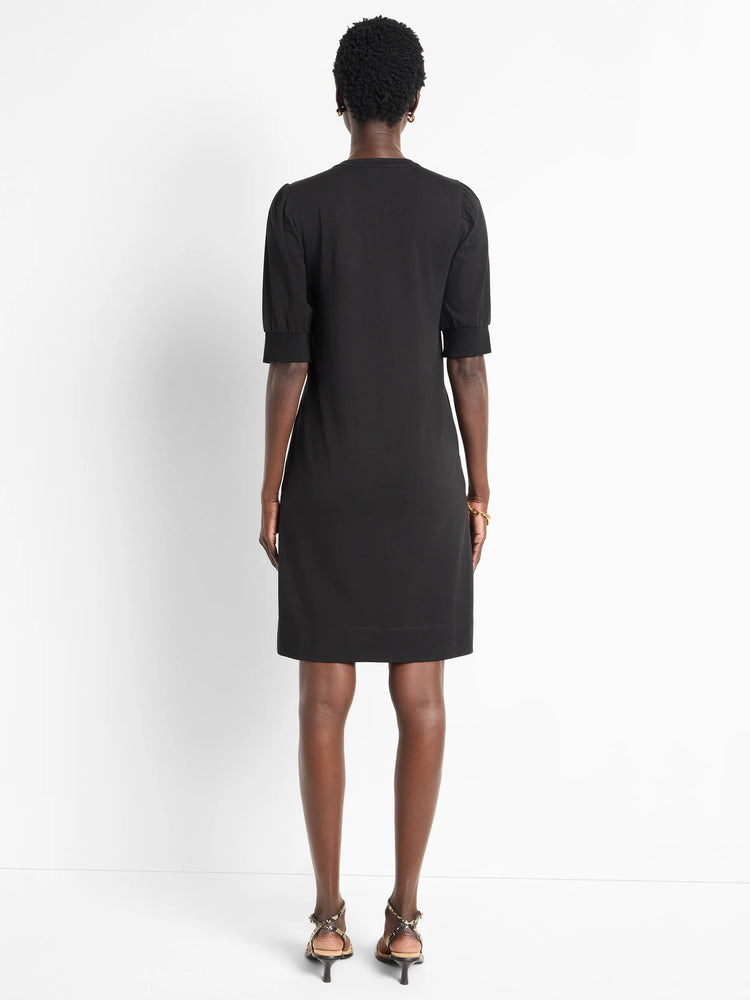 Black short-sleeved Henley dress, puff sleeves, straight hemline. Rear view.