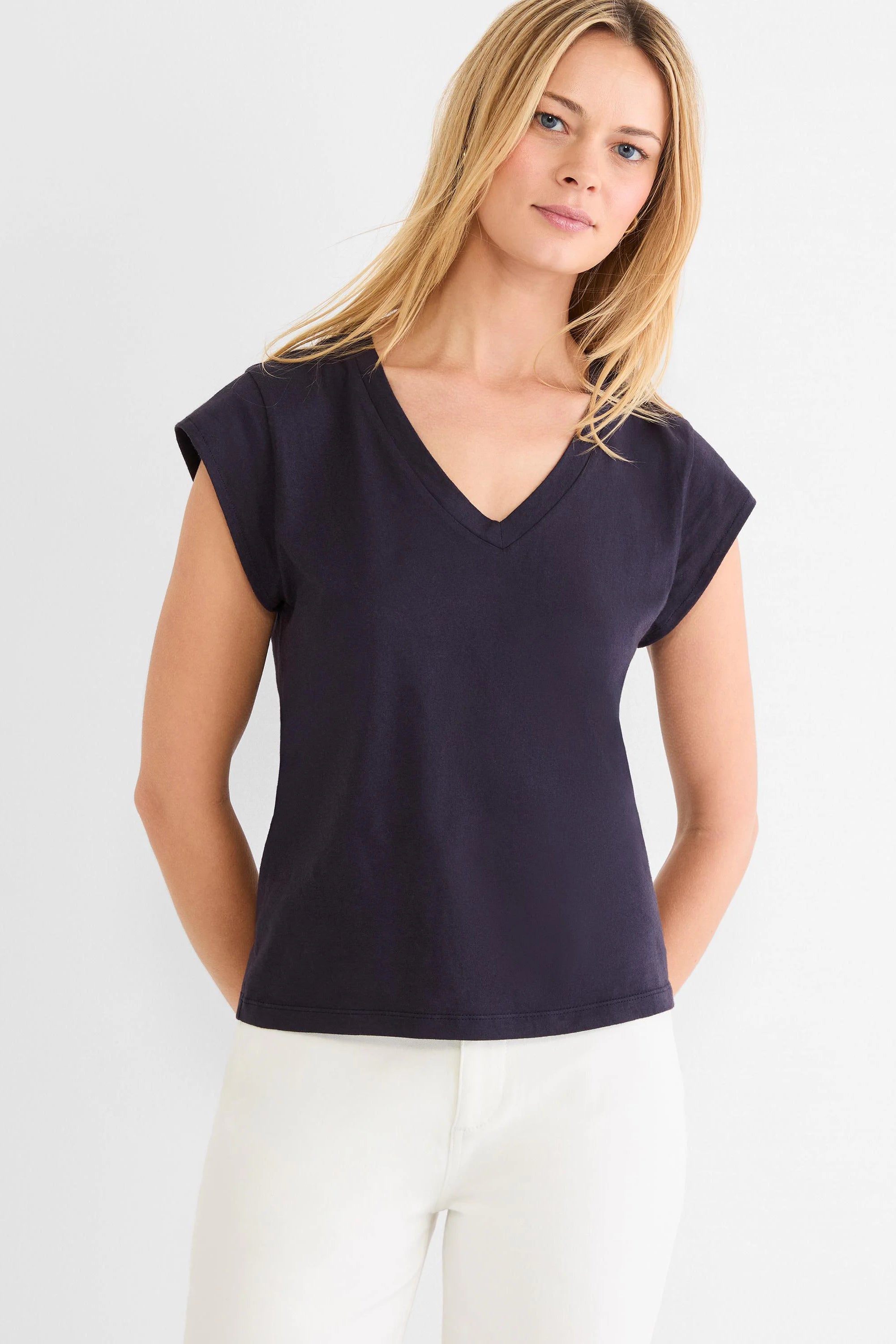 Navy V-neck tee with cap sleeves, modeled on a person.
