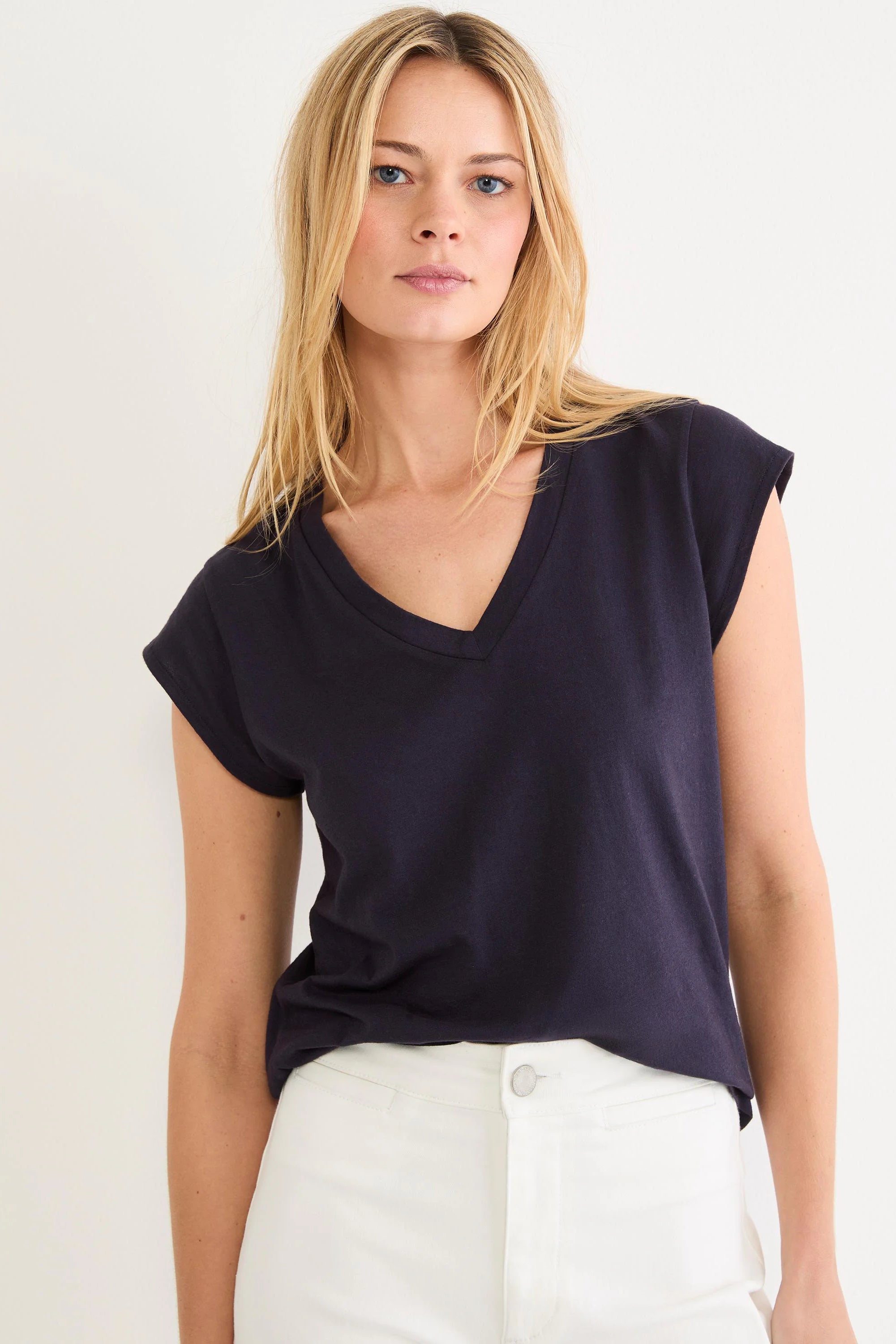 Dark navy V-neck tee with cap sleeves. Shows a relaxed fit on a model.