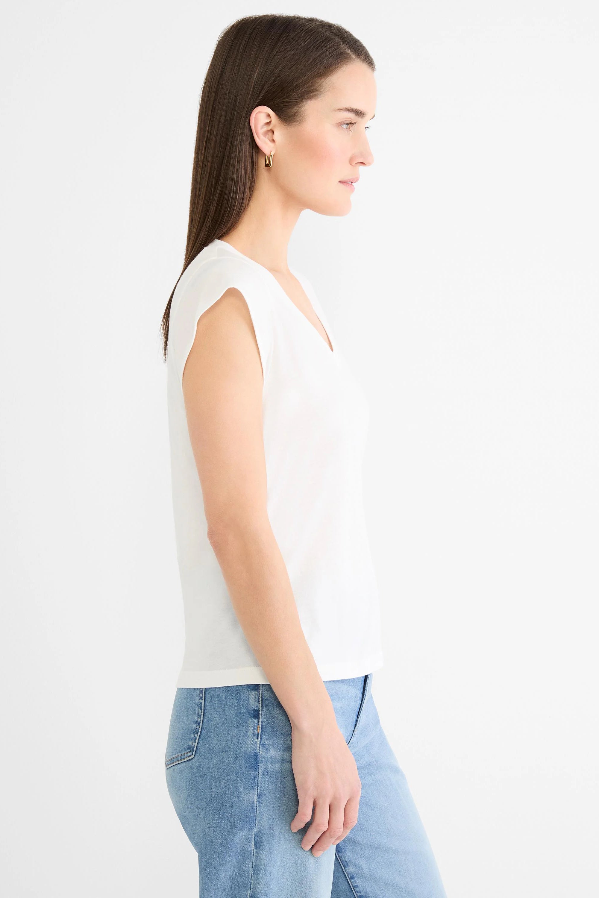White cap sleeve V-neck tee on model, side view, relaxed fit.
