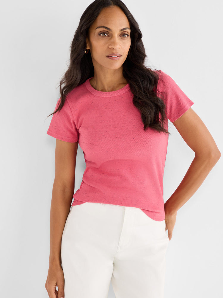 The model wears a slim pink heathered rib-knit short sleeve tee with a crew neck.