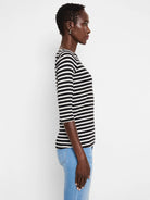 Black and white horizontal striped tee with 3/4 sleeves and a boat neck.