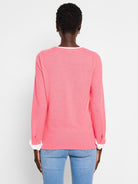 Pink double-layered sweater with cuffed sleeves;  white inner cuff detail.  Back view.
