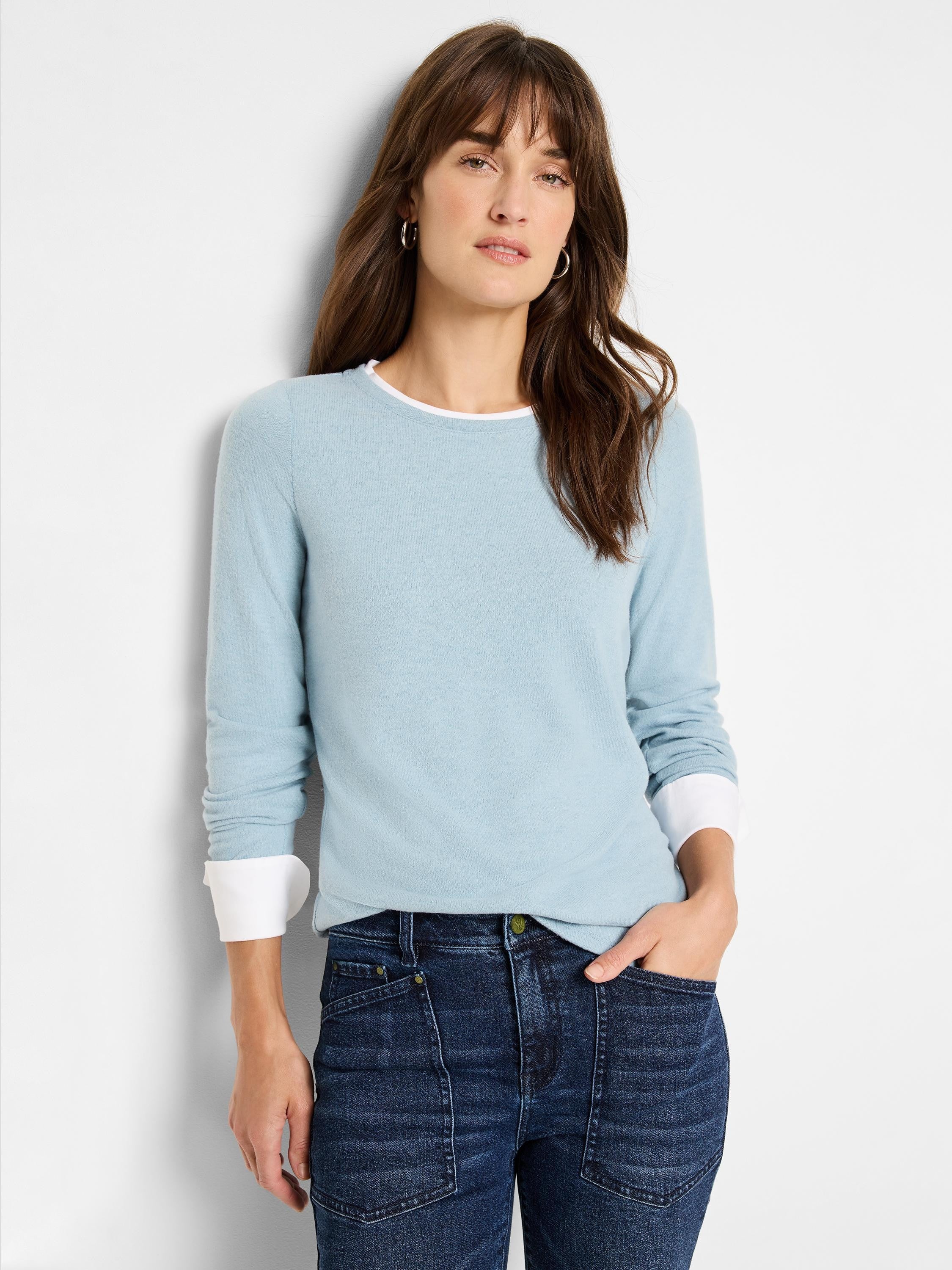 Light blue double-layered sweater with white cuffs.  Long sleeves, crew neck.