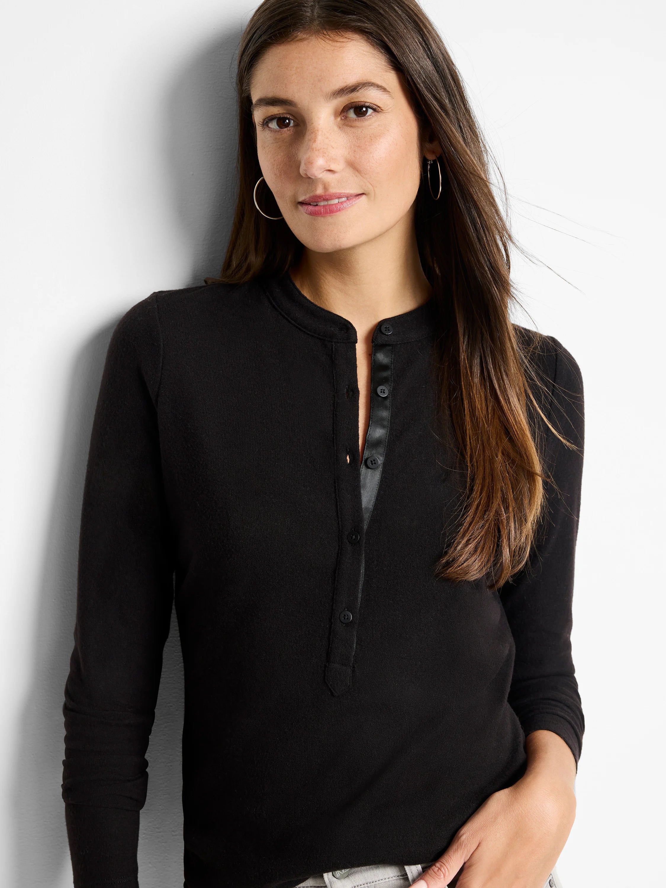 Black long-sleeve henley shirt with a placket of dark buttons.  Three-quarter sleeves.