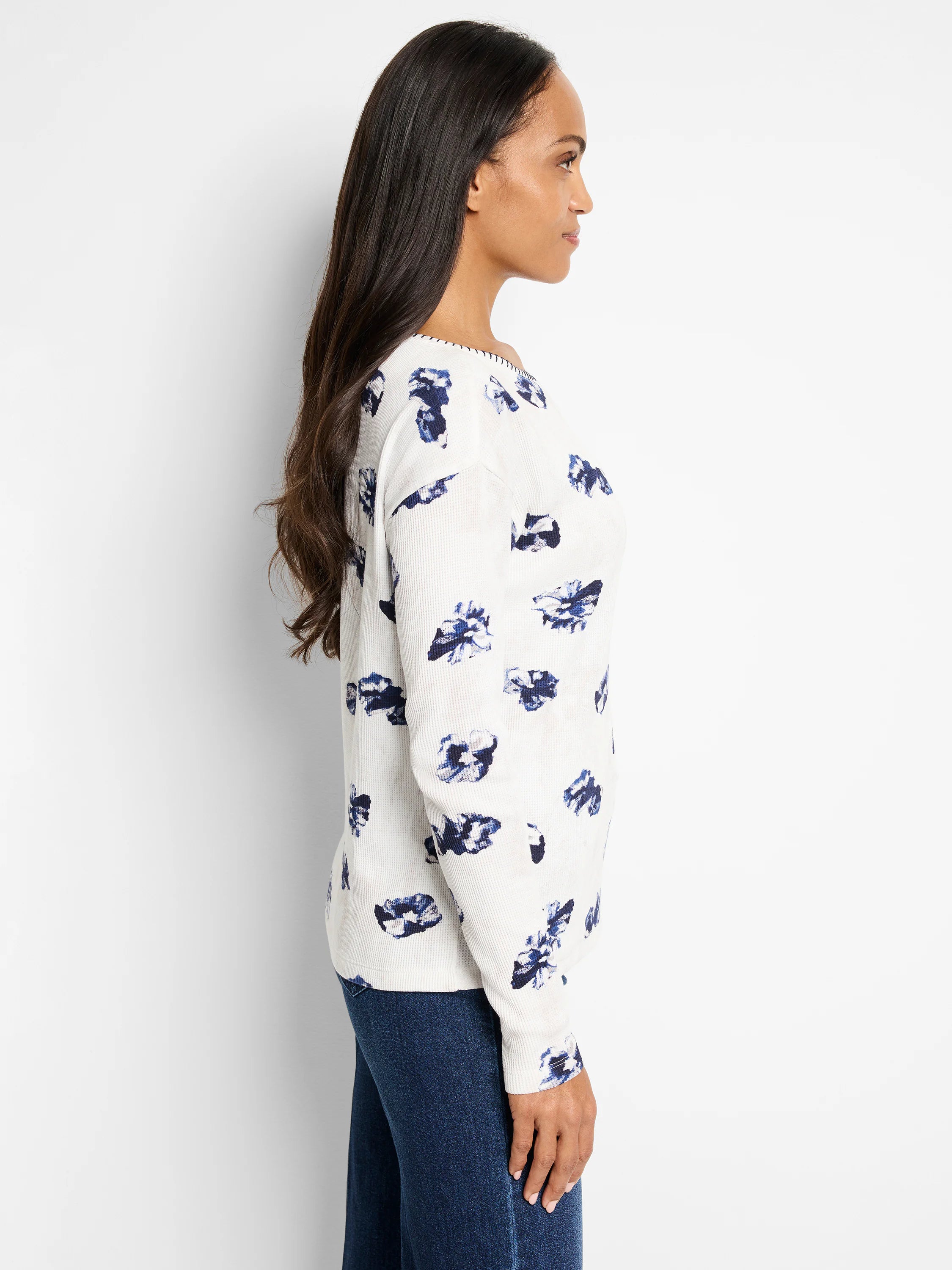 Off-white waffle-knit long-sleeve shirt with a scattered blue floral pattern.  Slight off-shoulder neckline.