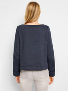 Dark gray boatneck top with dark navy ribbon trim at neckline and cuffs.  Back view.