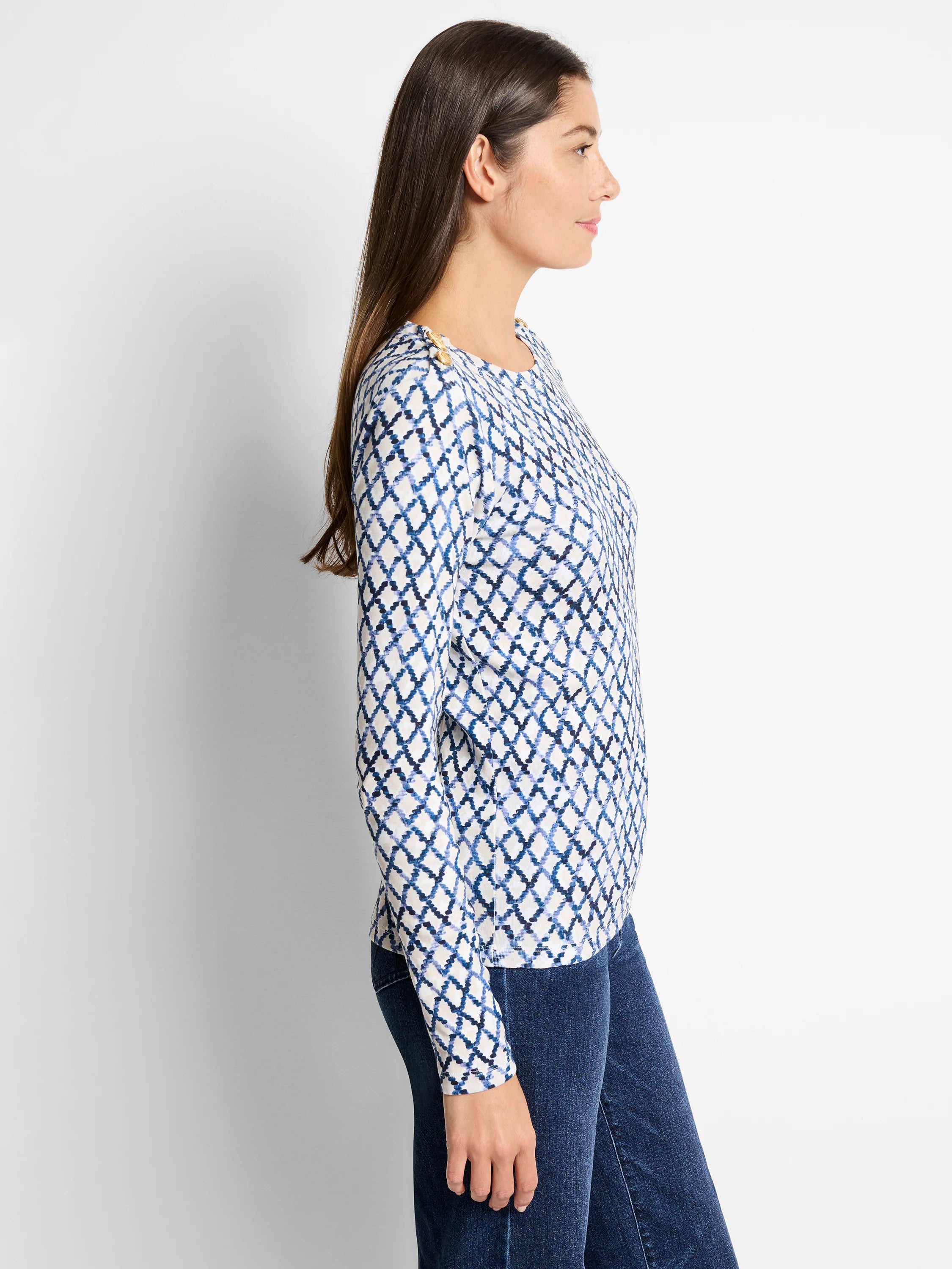 Off-white top with blue diamond pattern, long sleeves, and gold buttons on the shoulders.