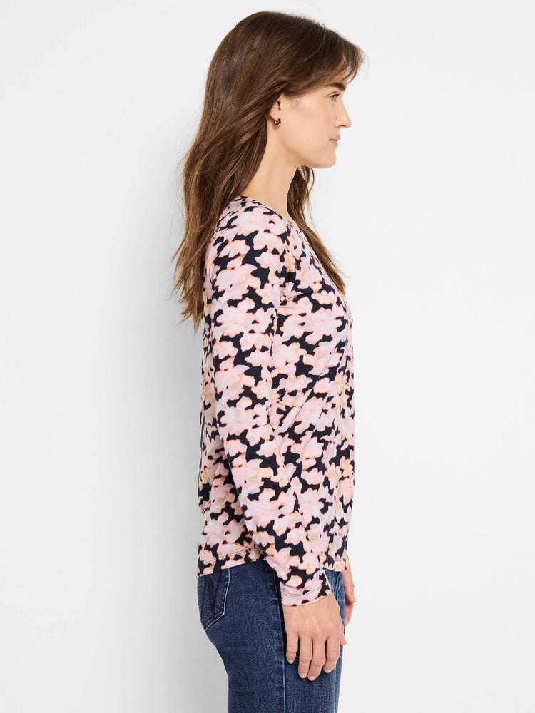 Crew neck, long-sleeve tee. Pink and black abstract print on dark background.