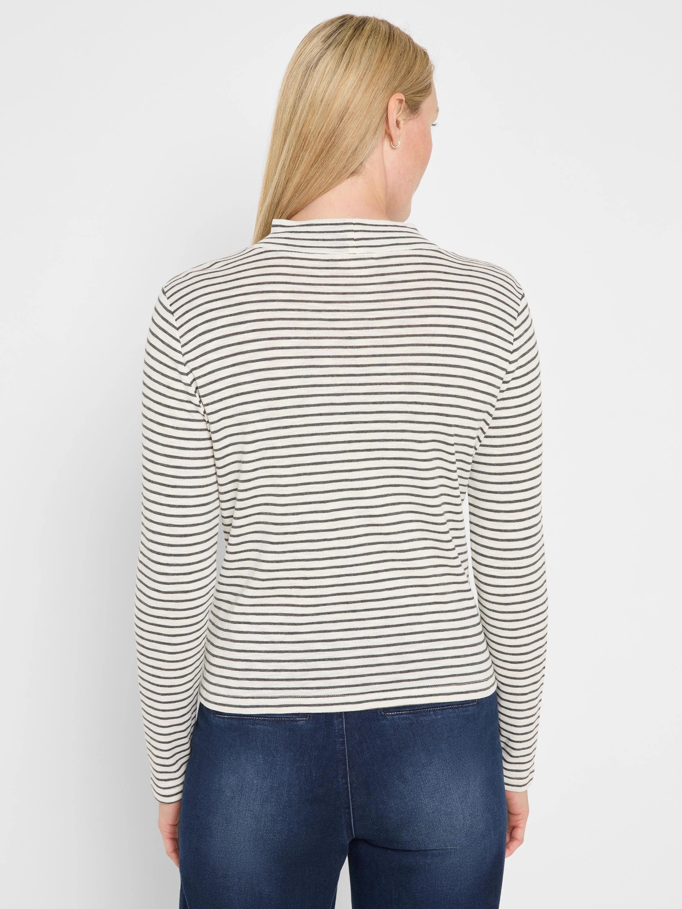 Off-white and dark grey striped long sleeve mock neck tee, shown from the back on a person.