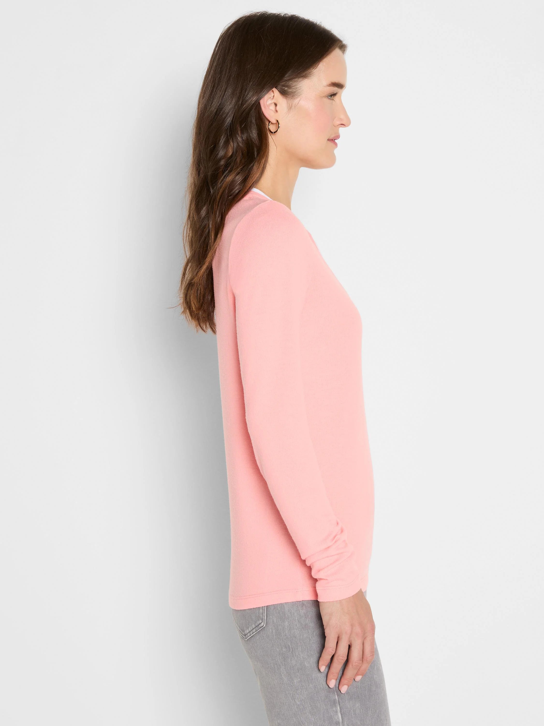 Light pink long-sleeve tee with a split neckline and a visible white inner layer, modeled in profile.