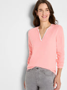 Peach long-sleeve tee with a white double-layer split V-neck.
