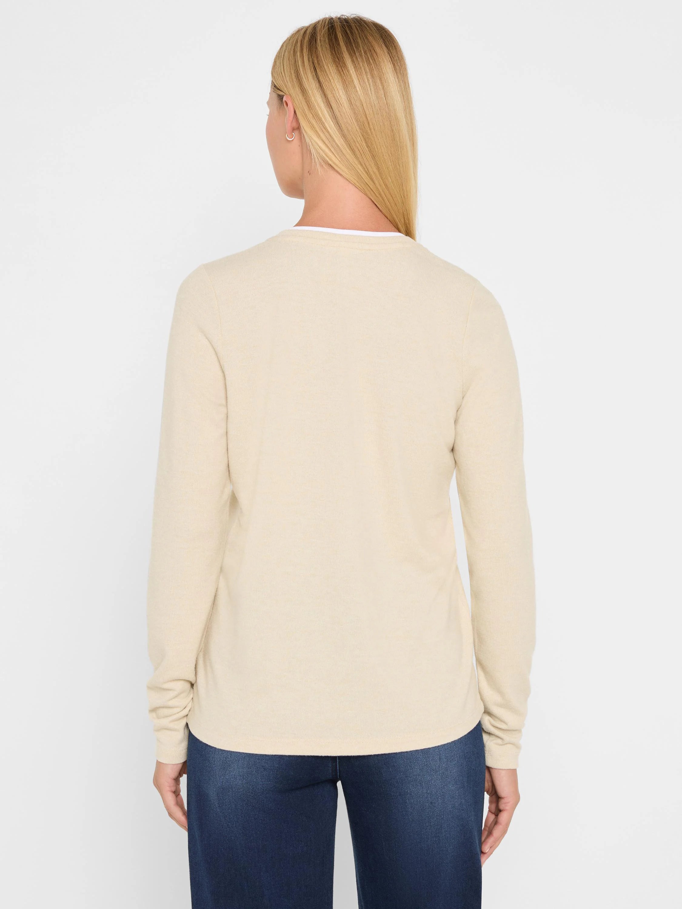Light beige jersey long-sleeve tee, back view. Features a double-layer neckline with a white underlayer.