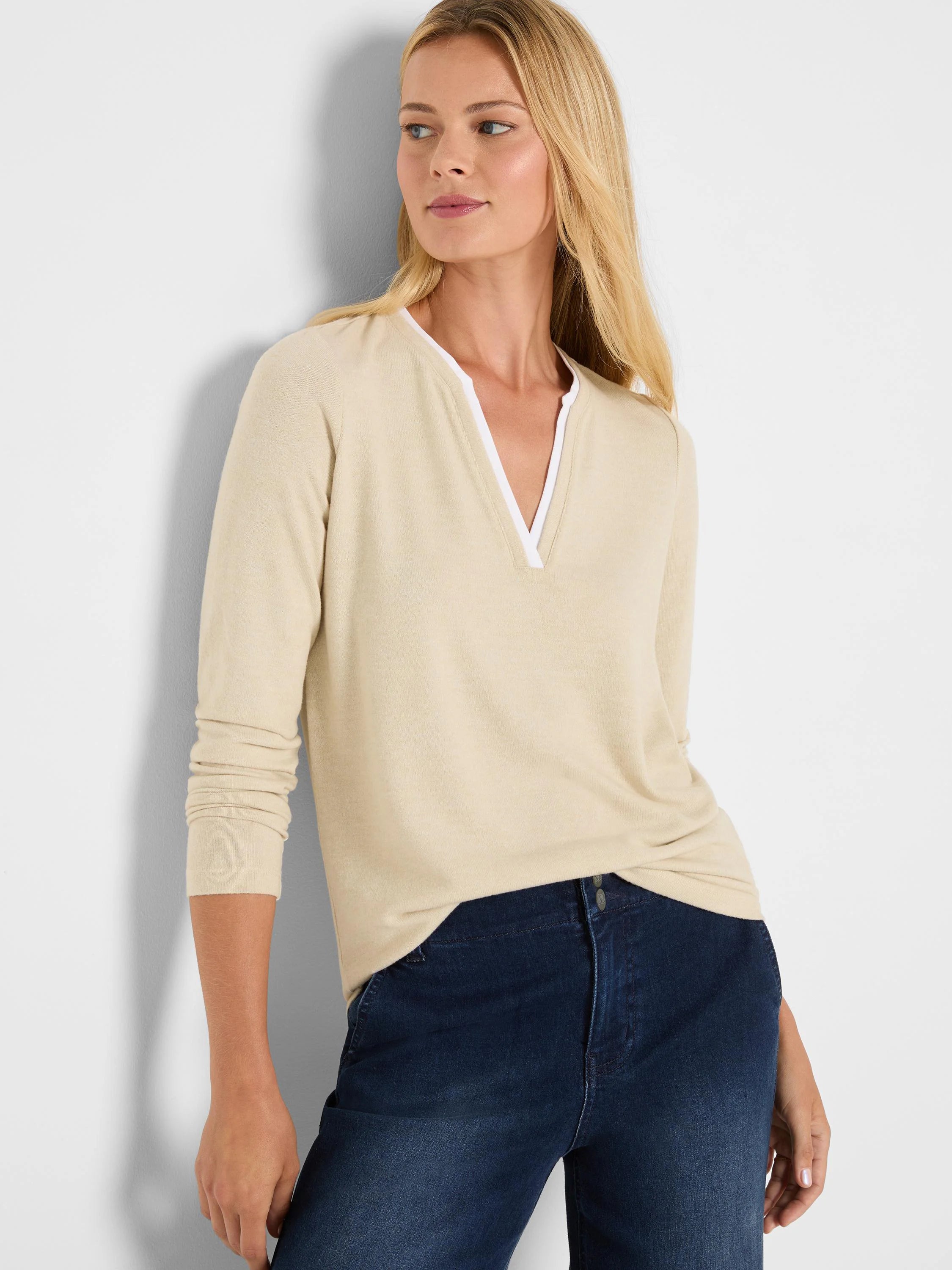 Light beige long-sleeve jersey tee with a white double-layer split V-neck.