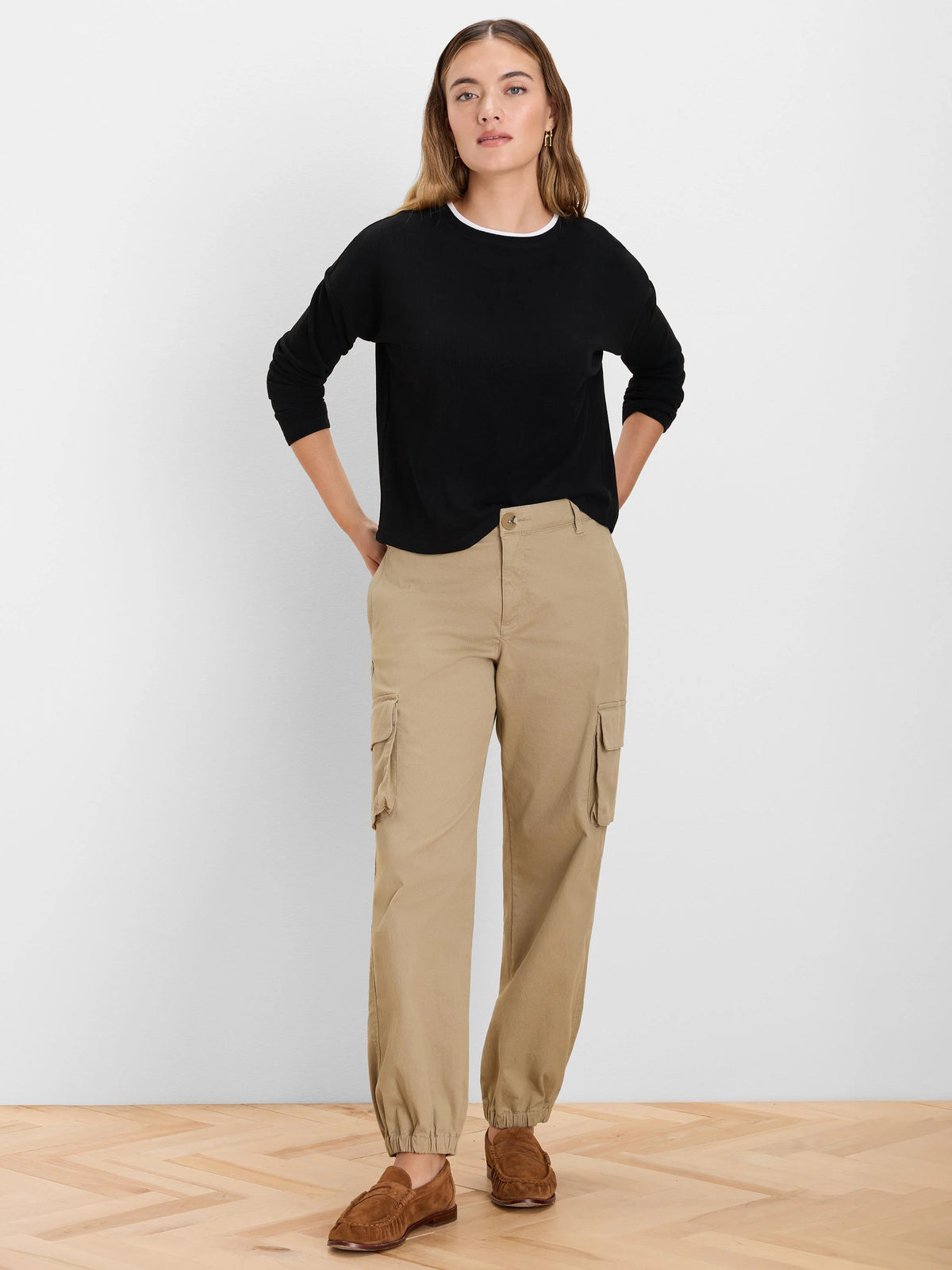 Black ribbed long-sleeve top with a white neckline trim, showing a double layer.