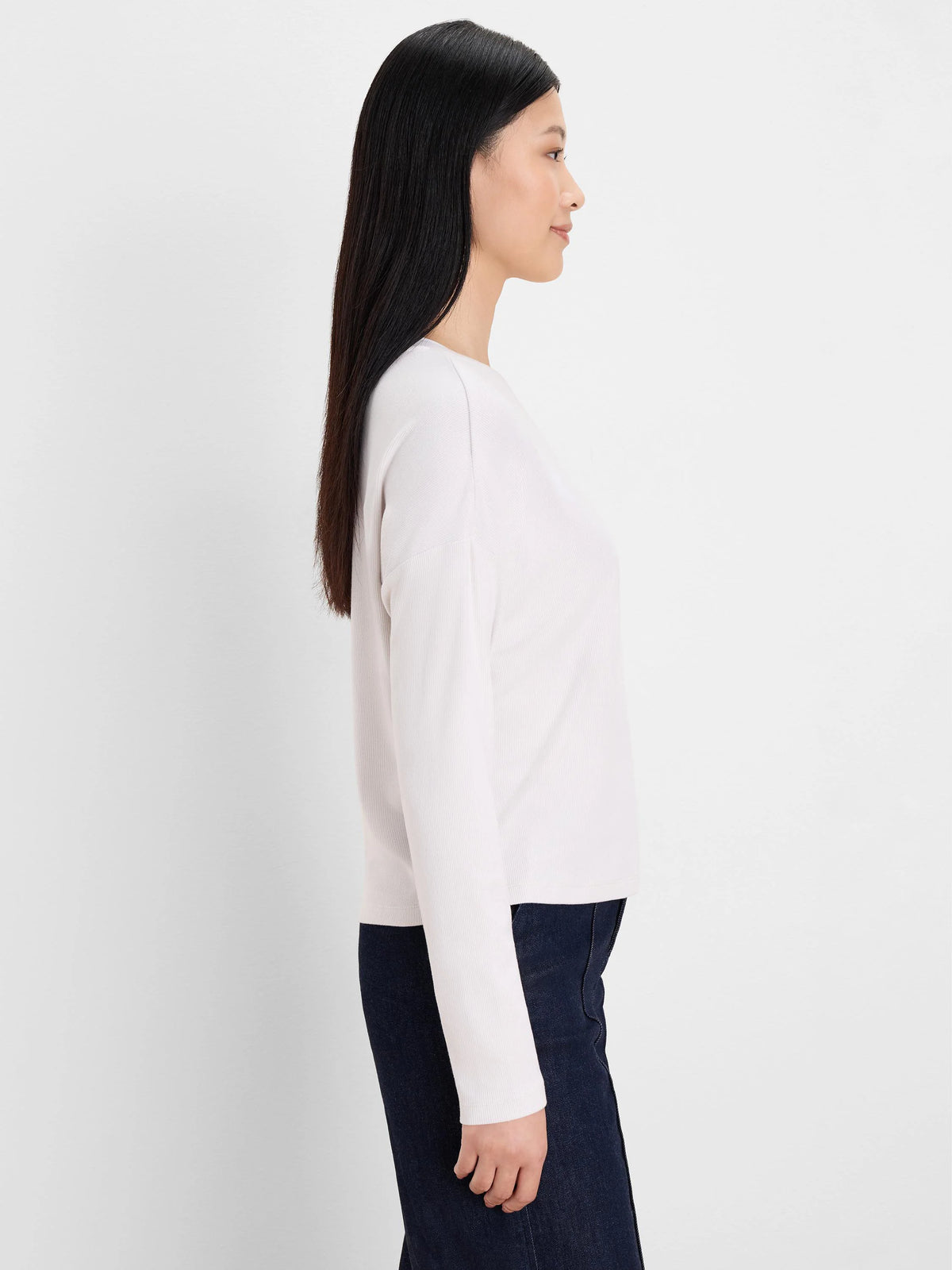 Light cream ribbed long-sleeve top, shown in a side view on a model.