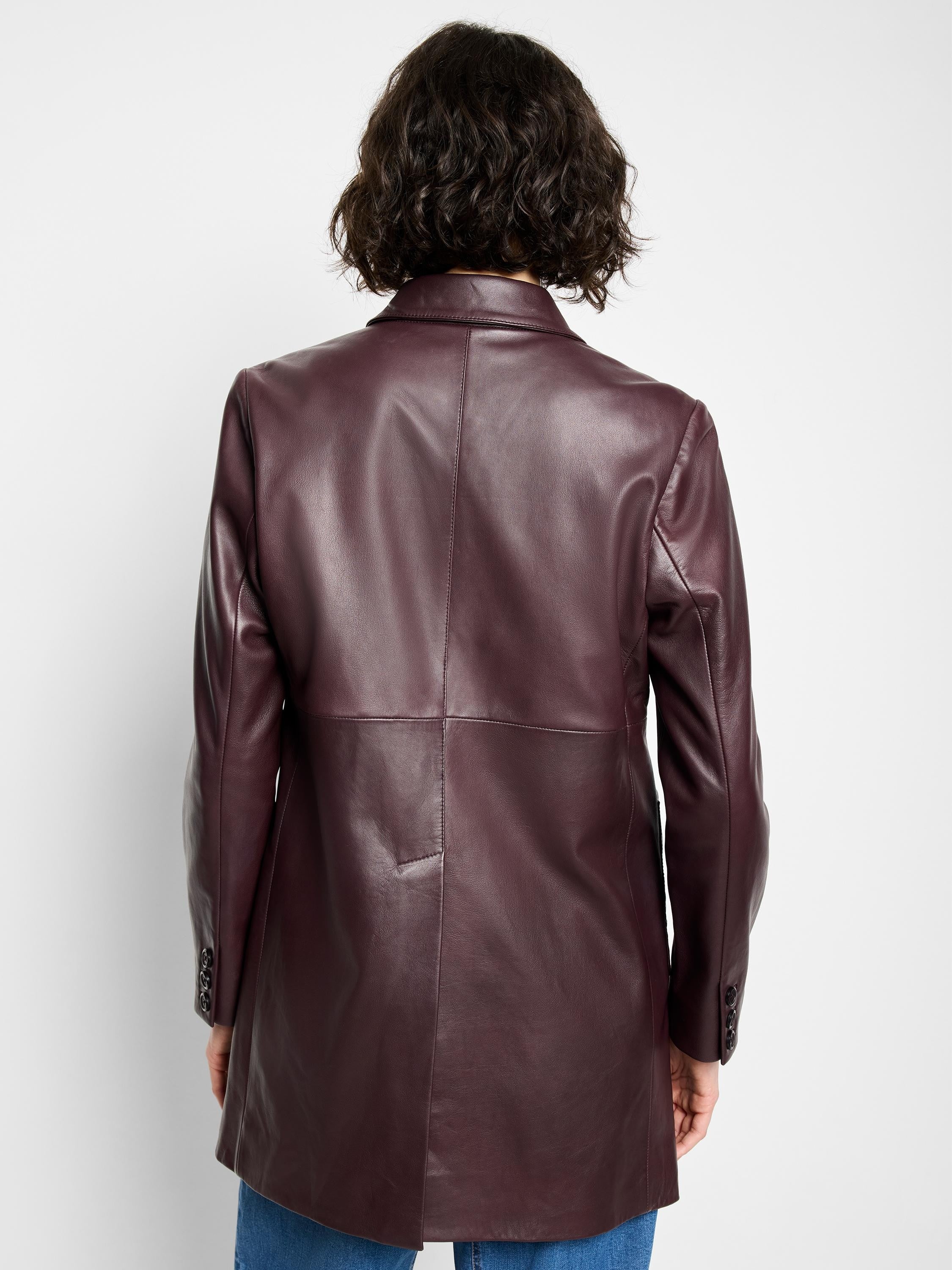 Burgundy leather car coat, long sleeves, buttoned cuffs, seen from the back.