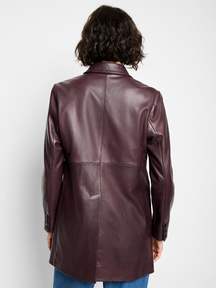 Burgundy leather car coat, long sleeves, buttoned cuffs, seen from the back.