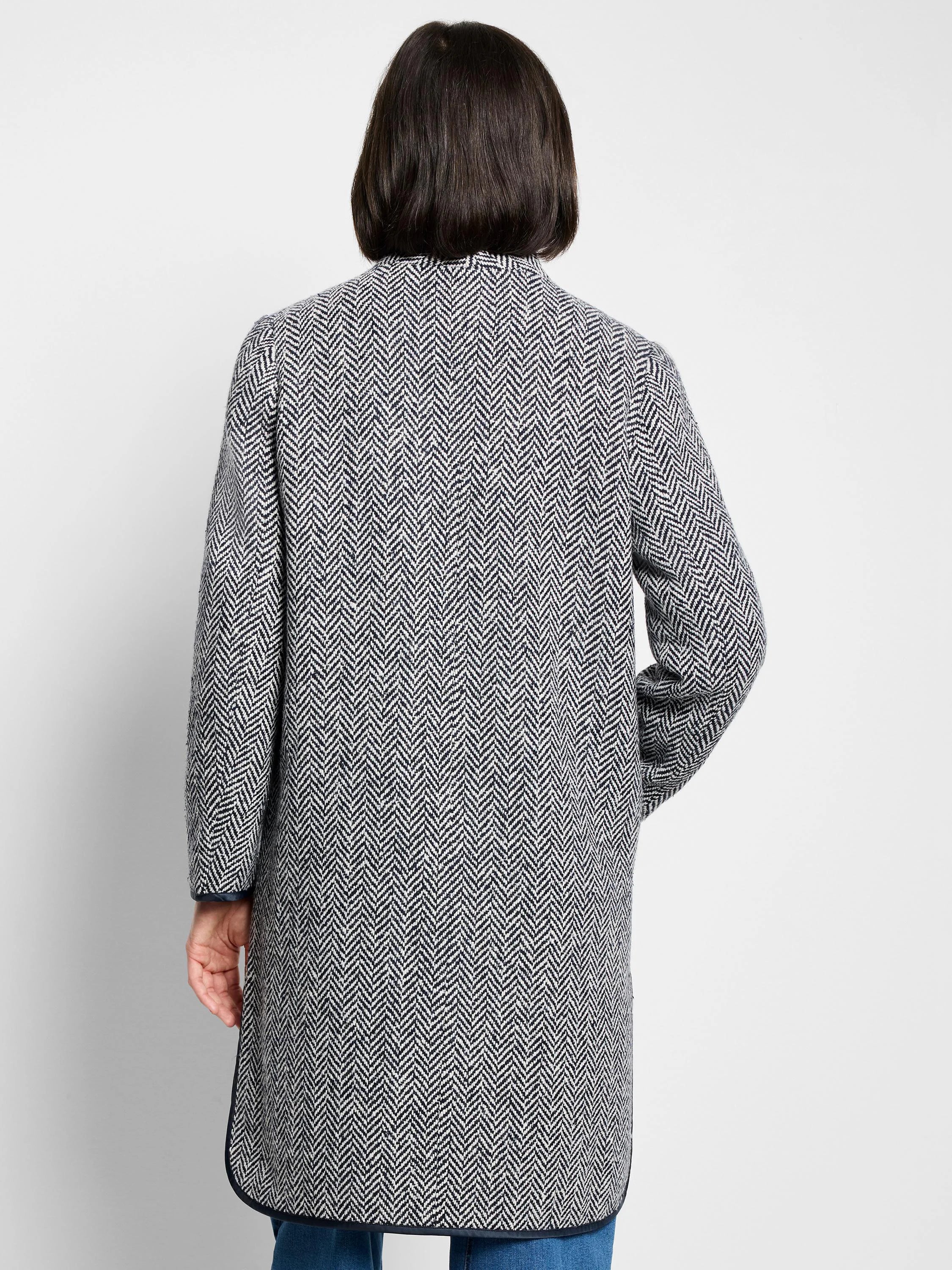 Herringbone pattern topcoat, navy and white.  Long sleeves, hip-length. Dark trim at hem and cuffs.