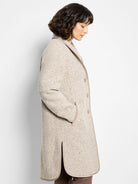 Beige herringbone wool topcoat with taupe trim, long sleeves, and a center front closure.