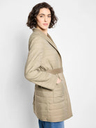 Beige quilted coat with a taupe-colored belt.  Features a collar and pockets. Reversible.