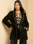 Black reversible top coat with dark trim and self-tie belt.