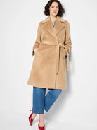Camel-colored belted wrap coat, knee-length, with pockets.