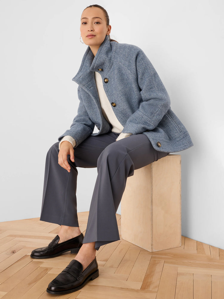 Textured blue wool mod coat with a stand collar and large dark buttons.