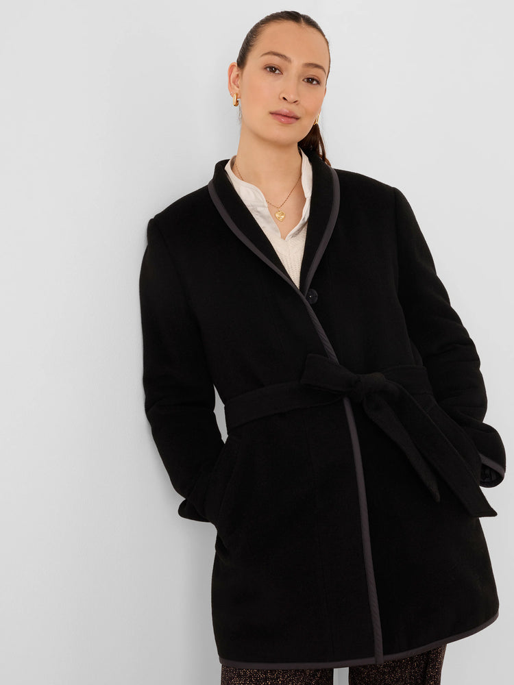 Black reversible wool coat with gray trim on shawl collar, front, and hem. Tied at waist with a black belt.