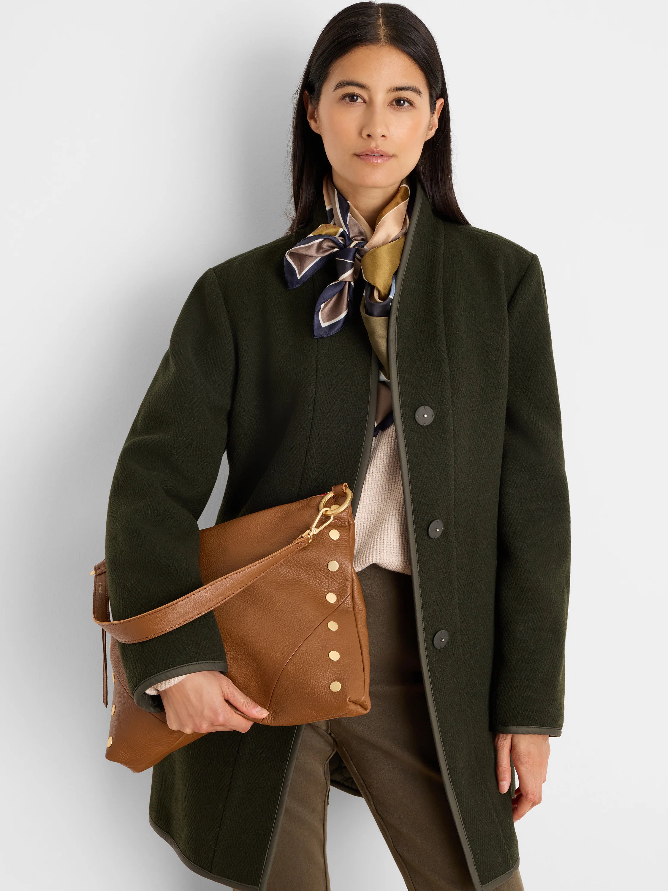Olive green wool top coat with herringbone pattern, dark trim, and dark buttons.