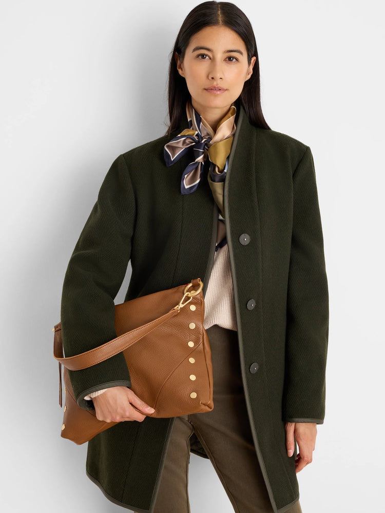 Olive green wool top coat with herringbone pattern, dark trim, and dark buttons.