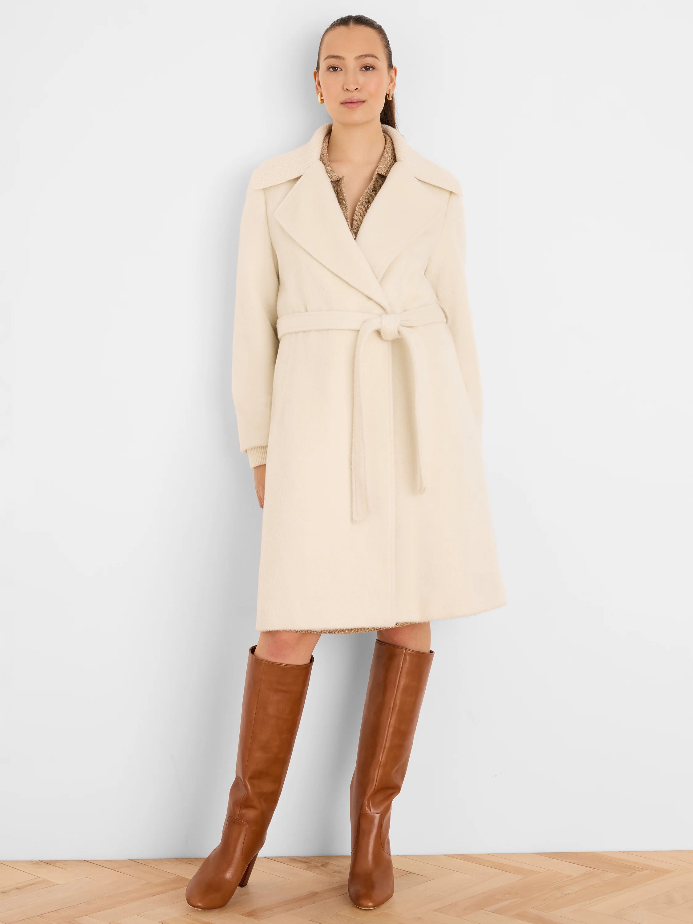 Ivory wrap coat with wide lapels, a self-tie belt, and knee-length hem. Visibly soft, fuzzy texture.
