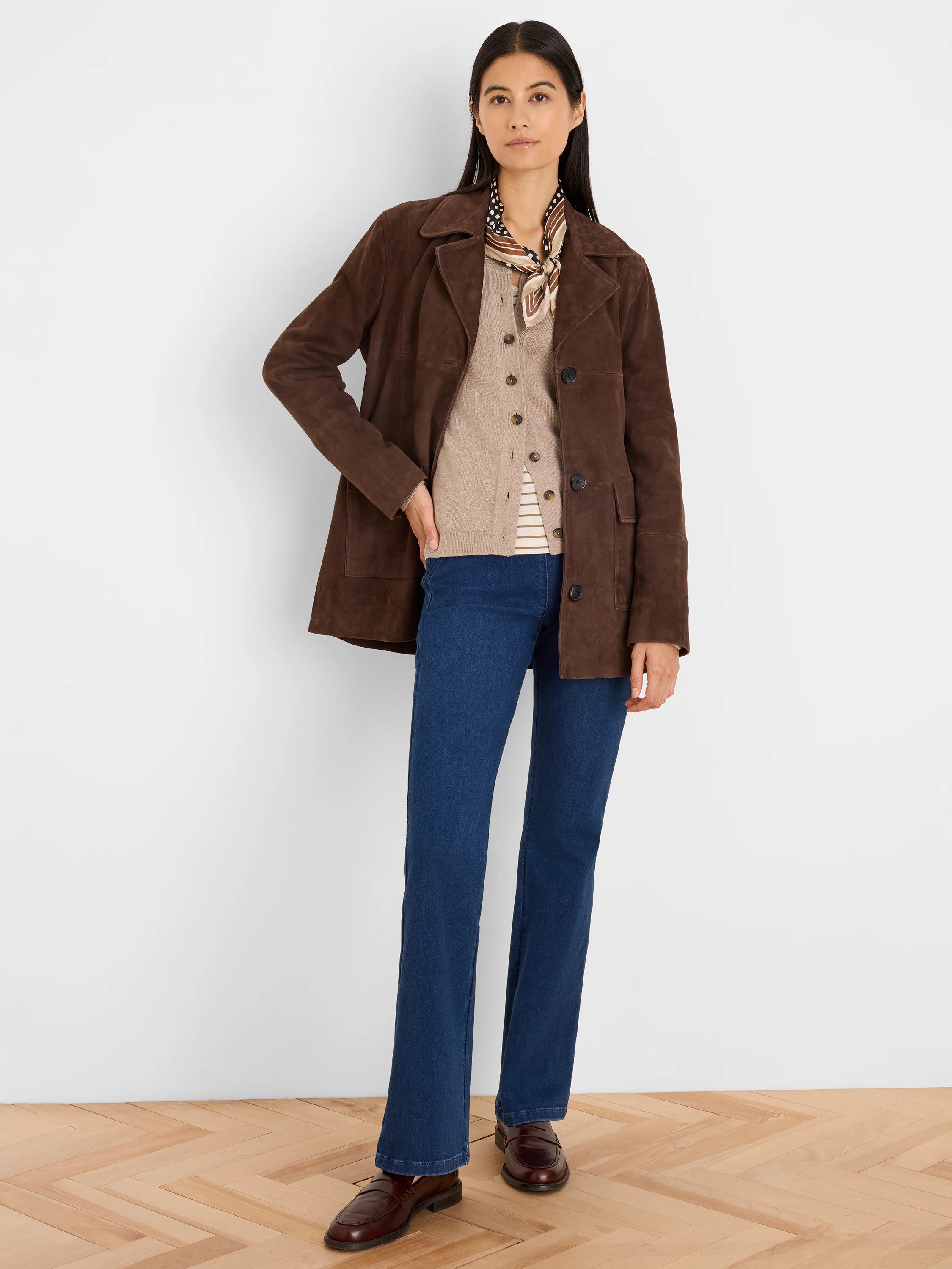 Dark brown suede coat with wide collar, button-front closure, and flap pockets. Relaxed, hip-length fit.