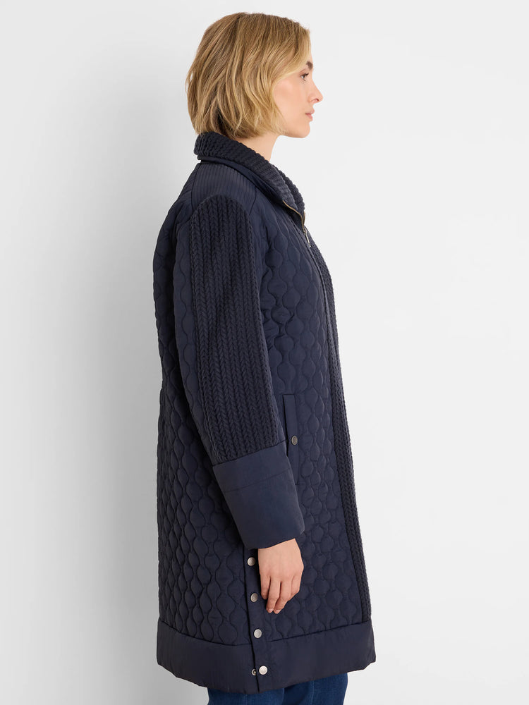 Navy parka: quilted body, braided knit sleeves, side snaps.