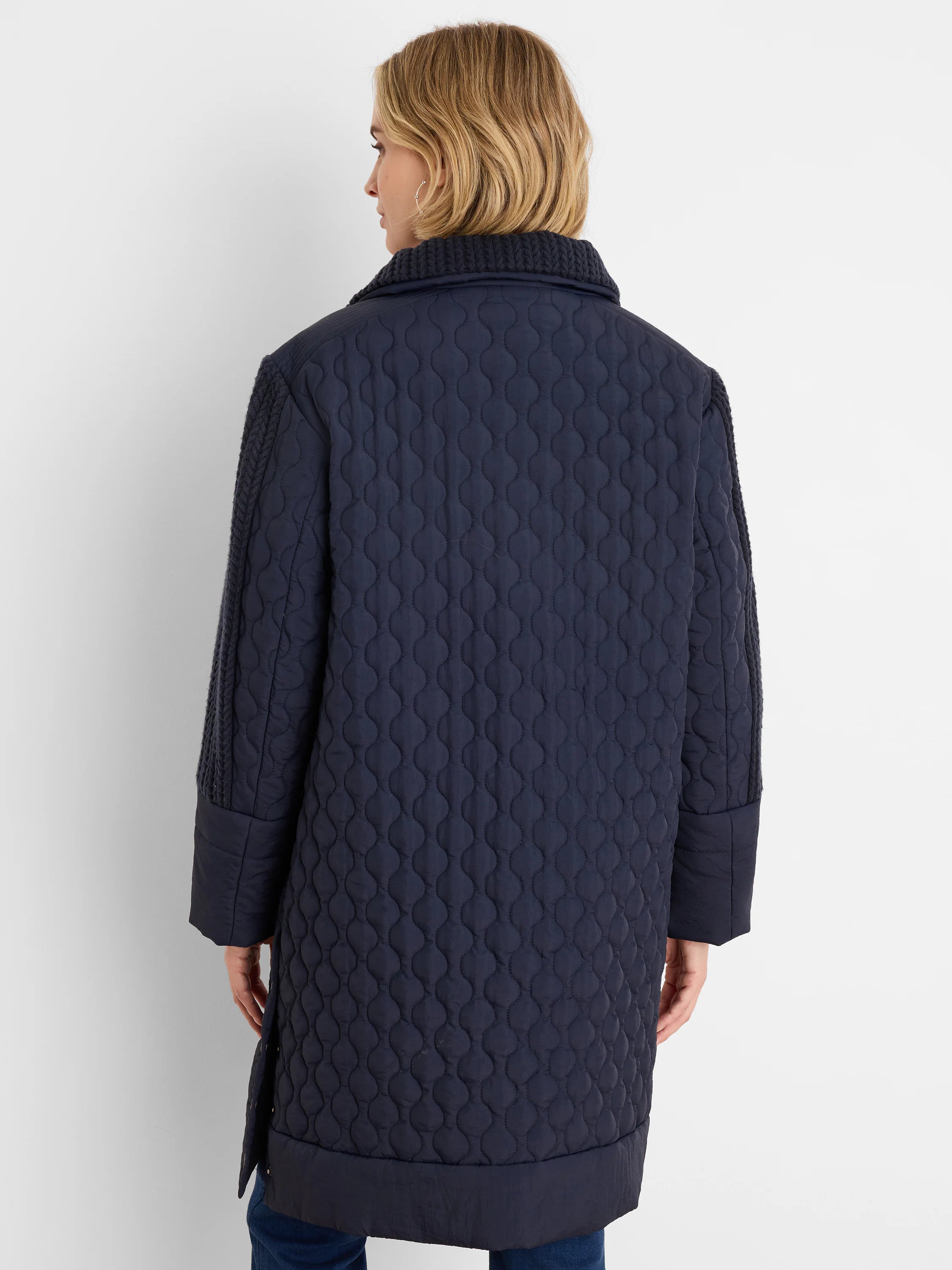 Navy mixed media puffer parka. Oval-quilted body, knit collar and upper sleeves.