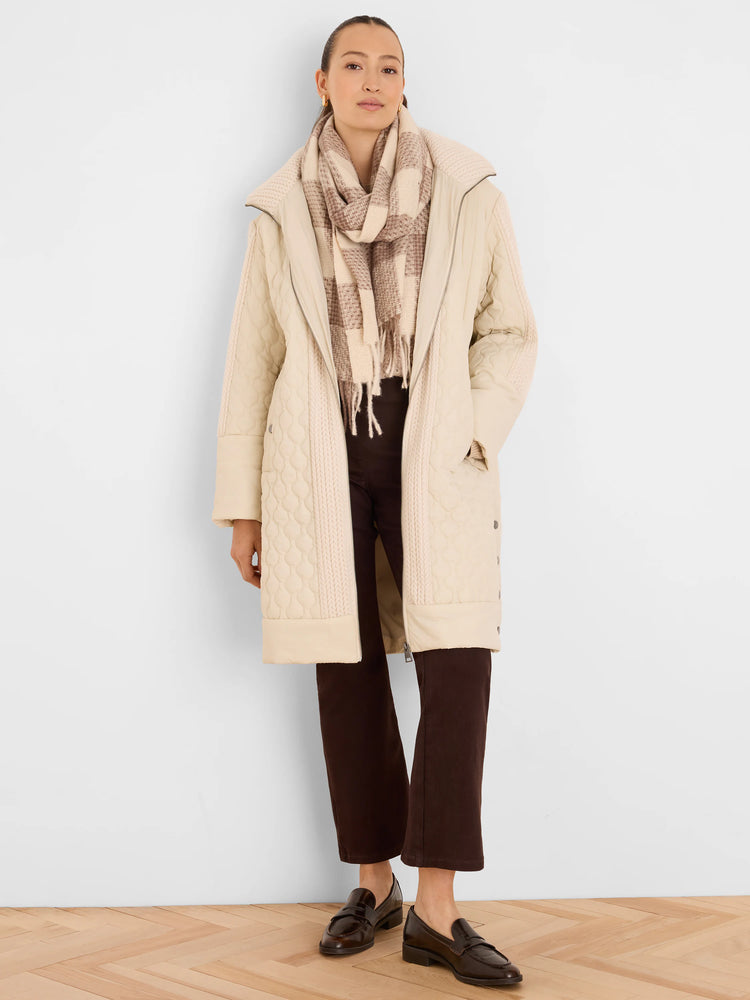 Cream mixed media puffer parka, quilted with cable knit side panels. Mid-length, zippered.