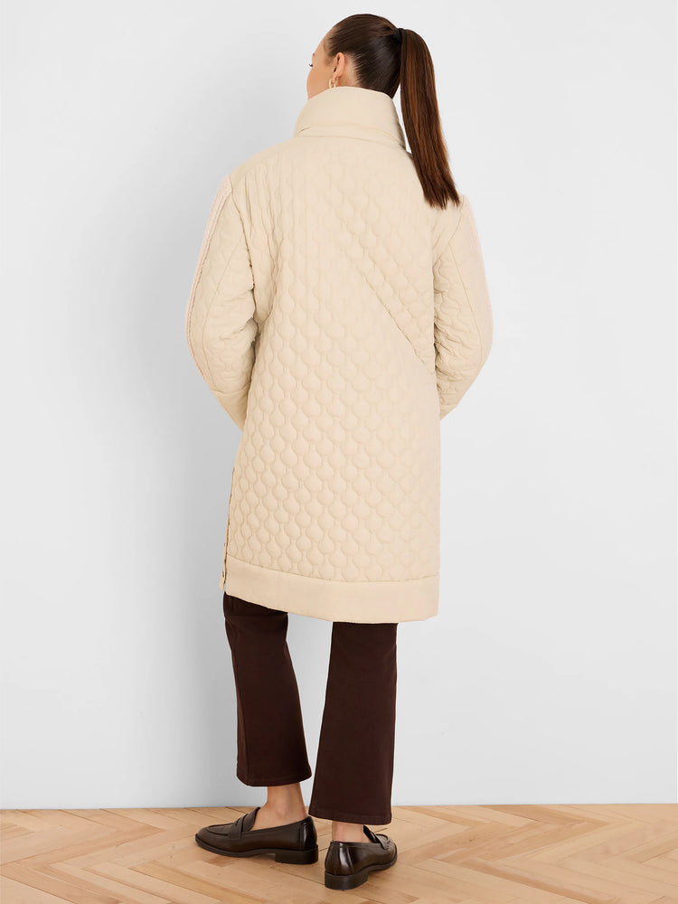 Cream mixed media puffer parka with a high collar and scalloped quilting.