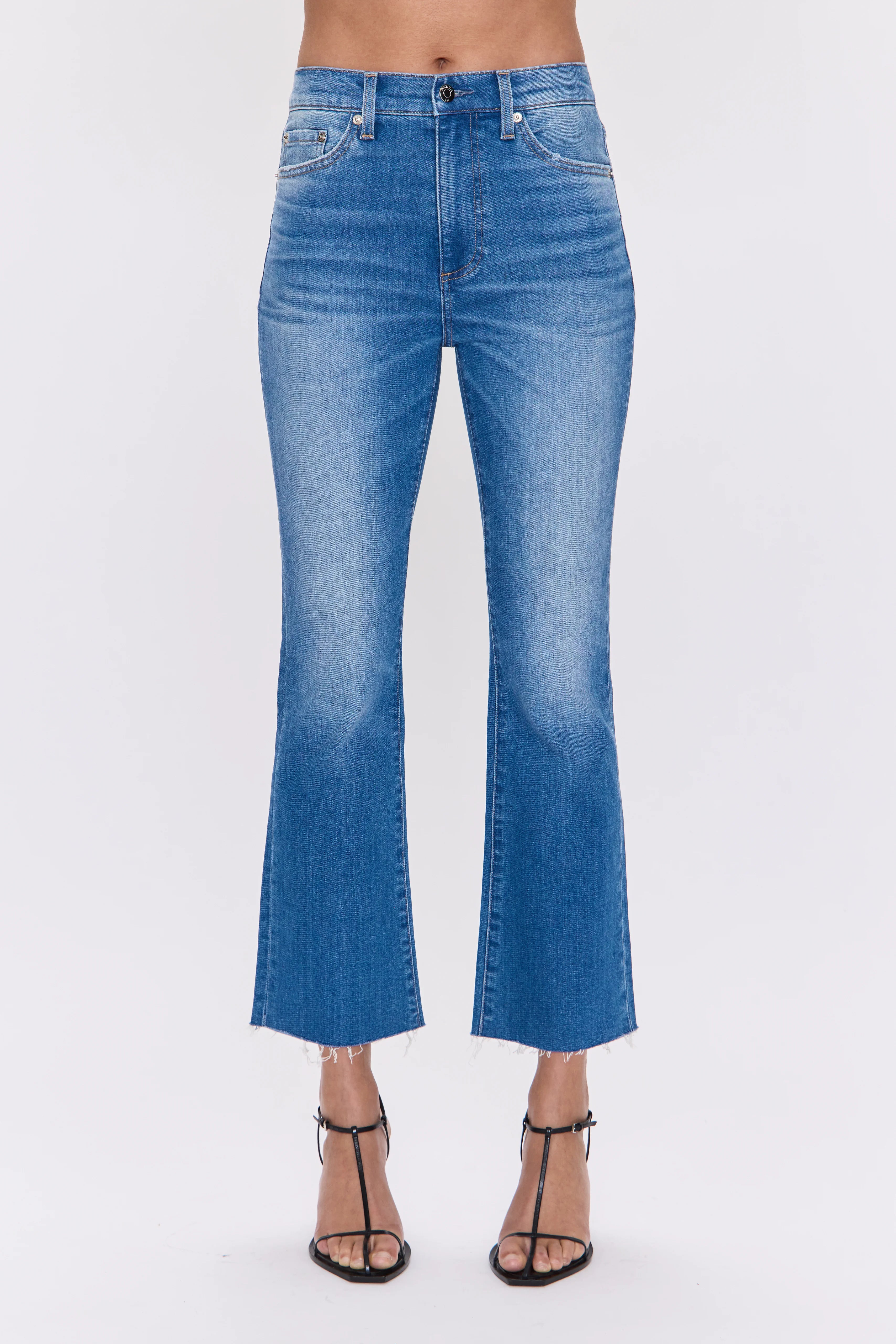 Medium blue high-rise crop bootcut jeans with a frayed hem.