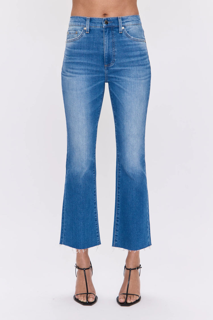 Medium blue high-rise crop bootcut jeans with a frayed hem.