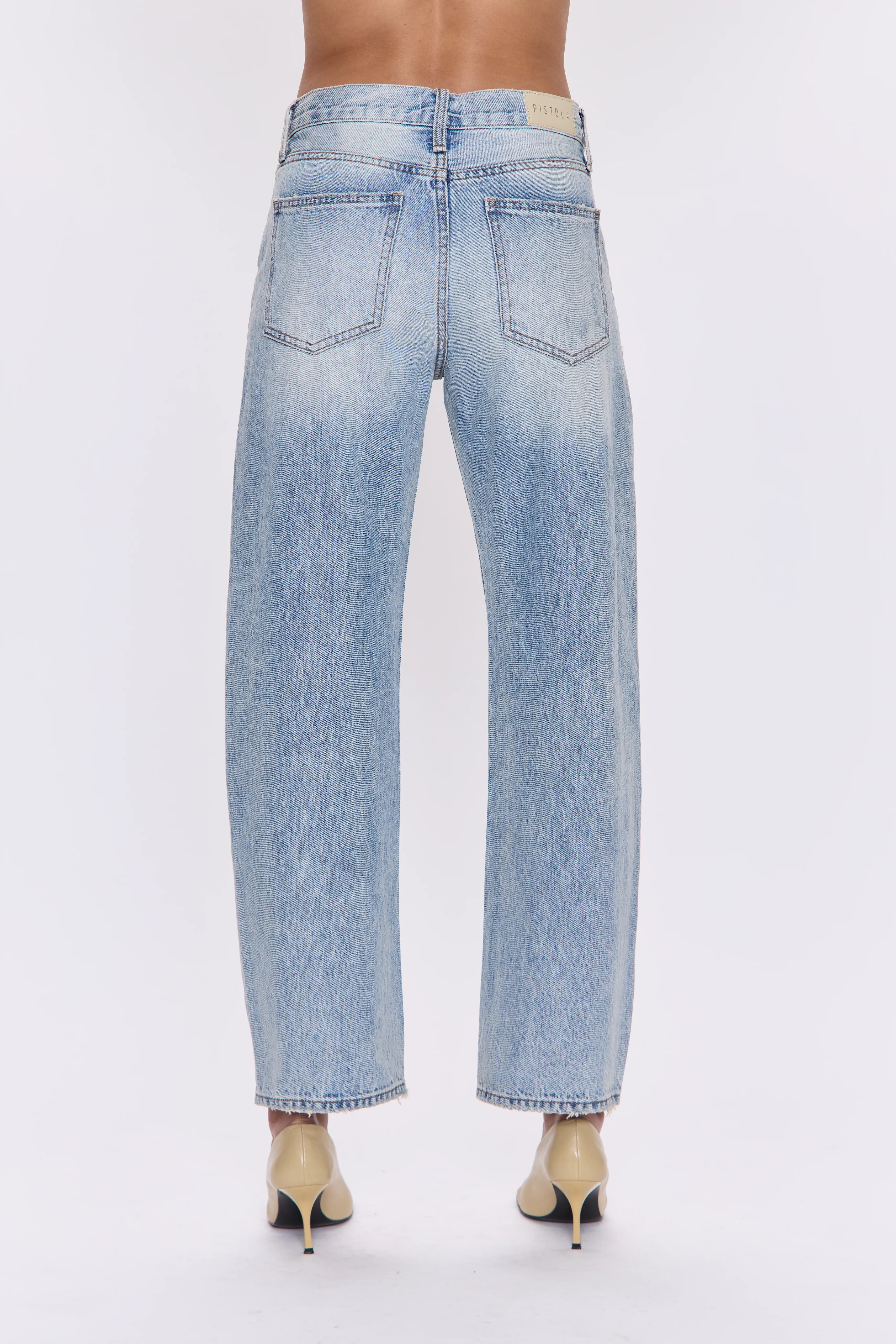 Light blue washed denim mid-rise straight jeans with faded thighs, back pockets, and raw hem.