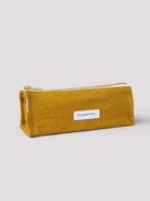 Mustard yellow cotton pencil case with gold zipper and small white label.