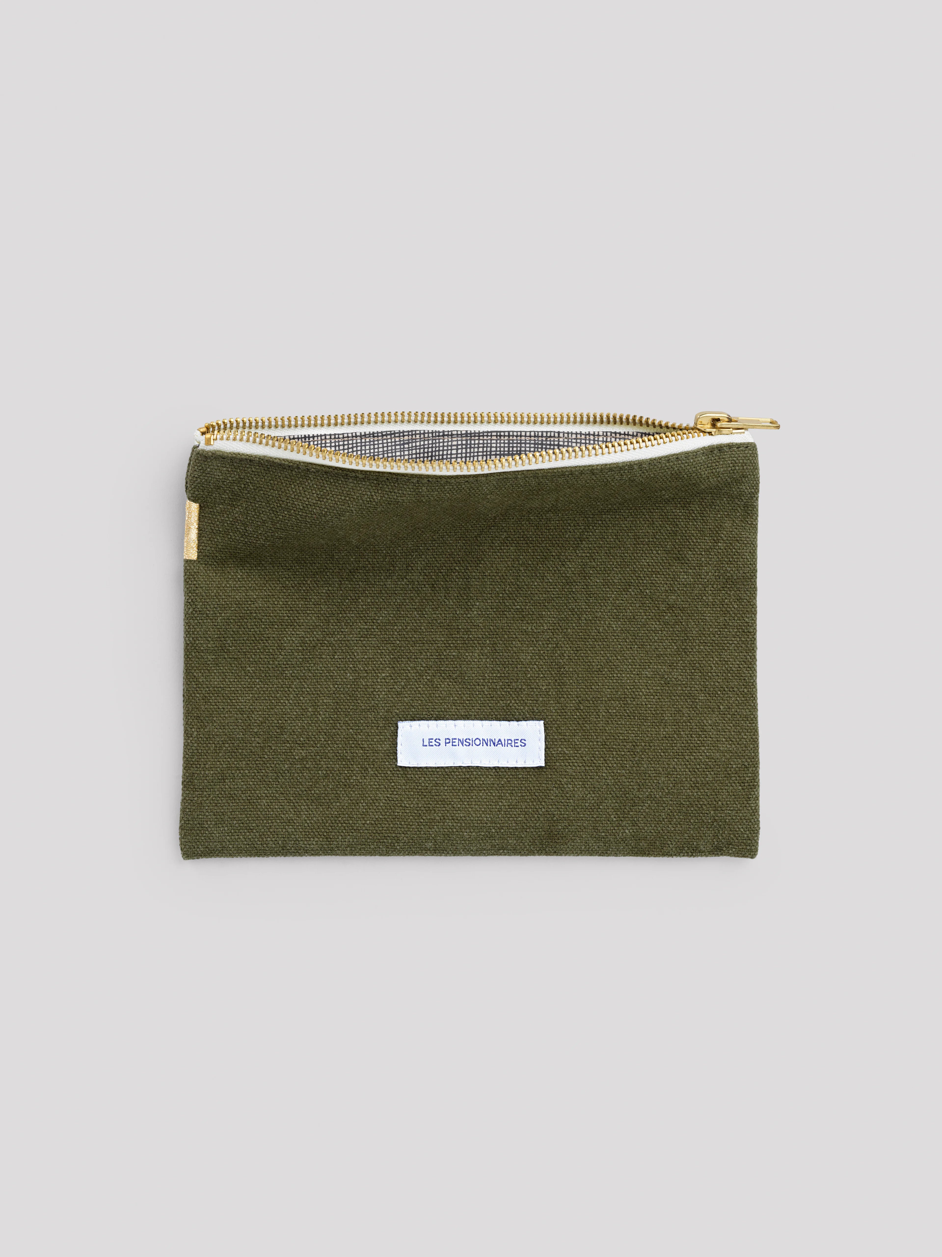 Olive green pouch with gold zipper, white brand label on front, and black & white checkered lining visible.