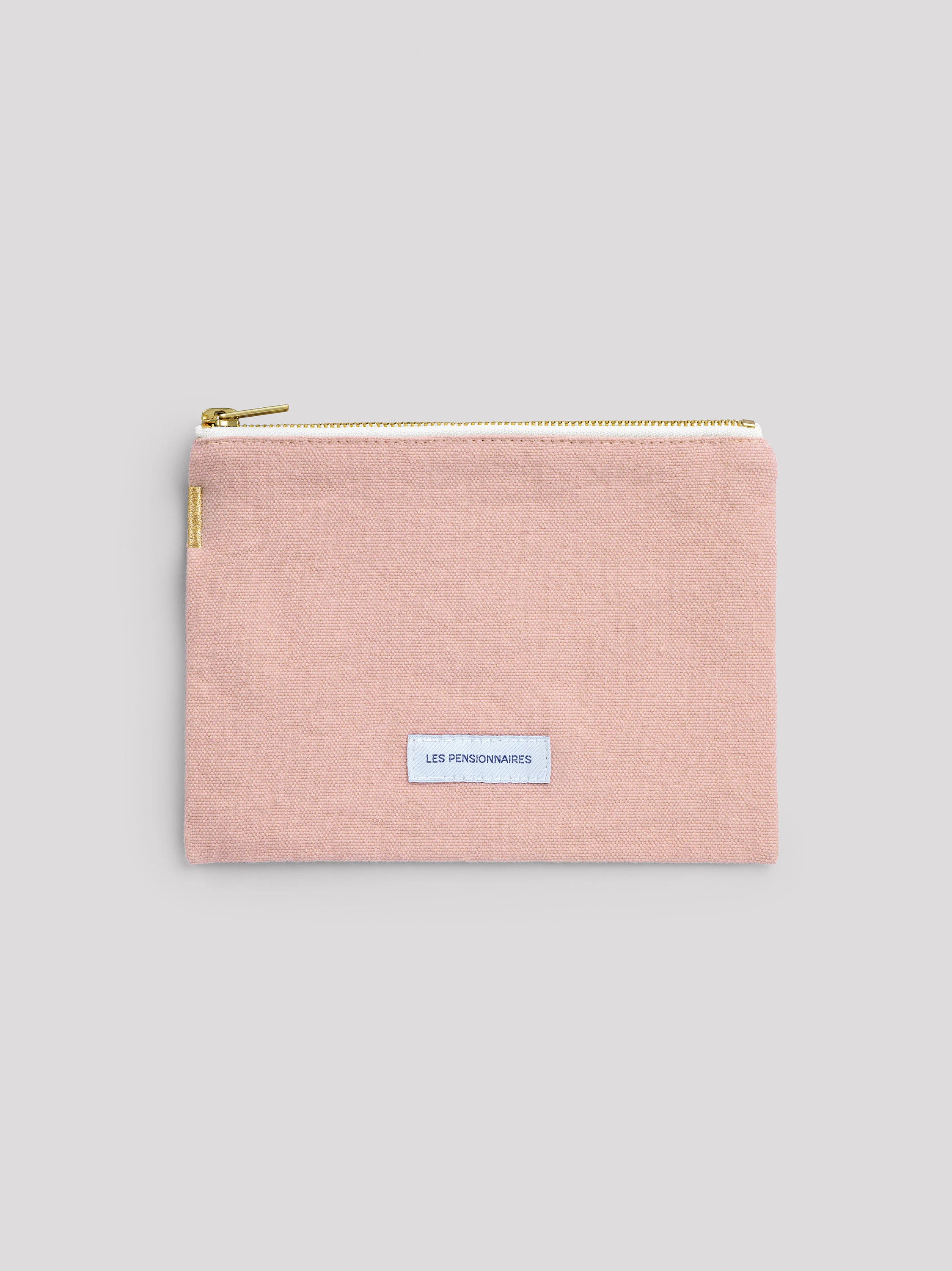 Light pink cotton pouch with a gold zipper and a small blue "LES PENSIONNAIRES" label centered on the front.