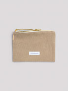 Beige cotton zipper pouch with a gold metal zipper, white "LES PENSIONNAIRES" label, and a gold embroidered stripe.