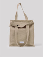 Beige cotton tote bag with two top handles and a partially open zipper closure.
