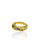 Hammered gold ring with scattered clear gems and several larger, irregular silver-toned stone inlays.