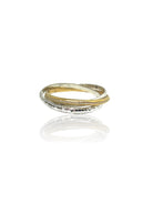 Three intertwined rings: one hammered silver, one smooth gold, one gold with pave stones.