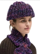 Variegated purple, pink, blue chunky knit hat on model. Features thick stitches and a ribbed brim.